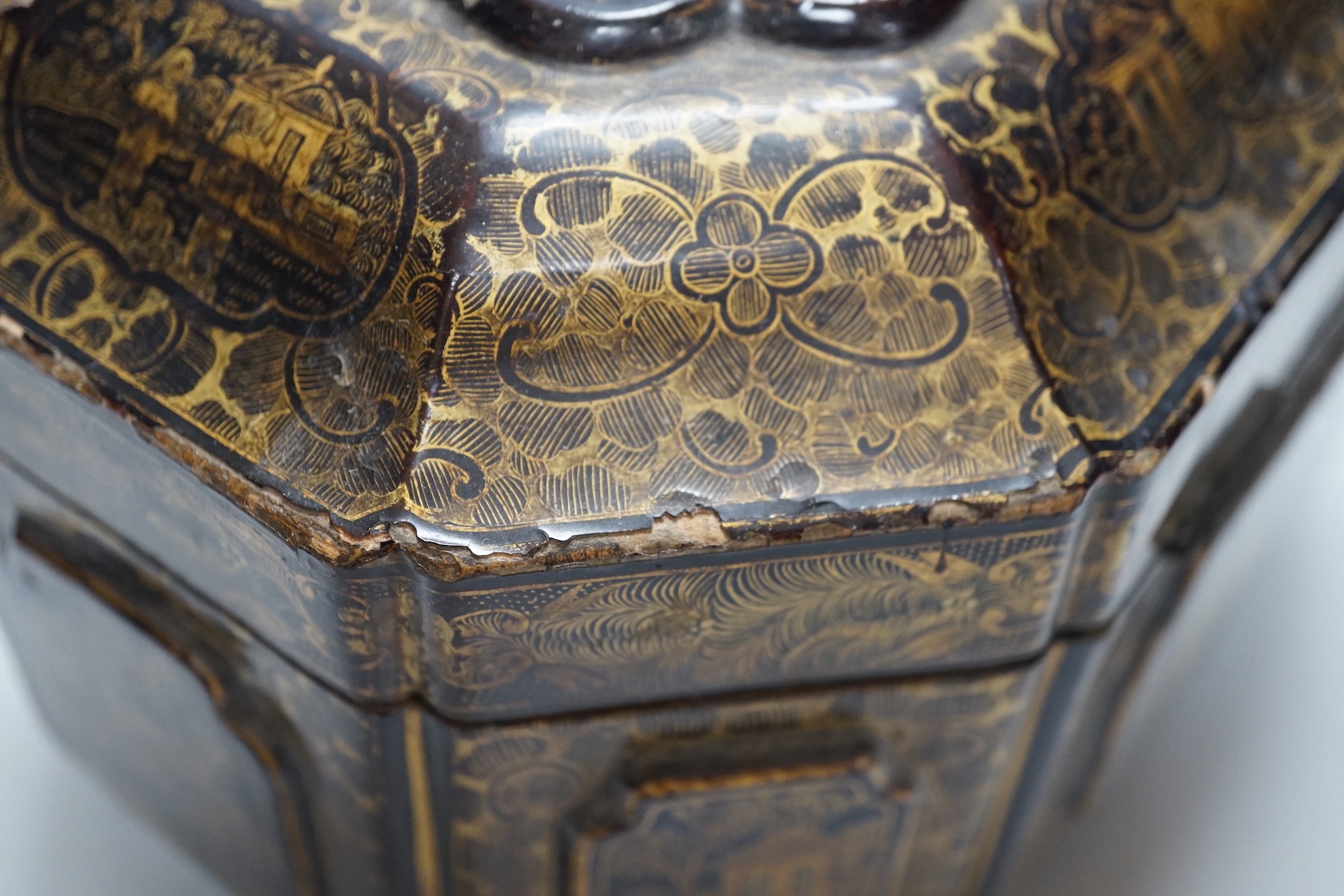 A 19th century Chinese chinoiserie lacquered sarcophagus form tea caddy, pewter lined interior with bone handles, 23cm